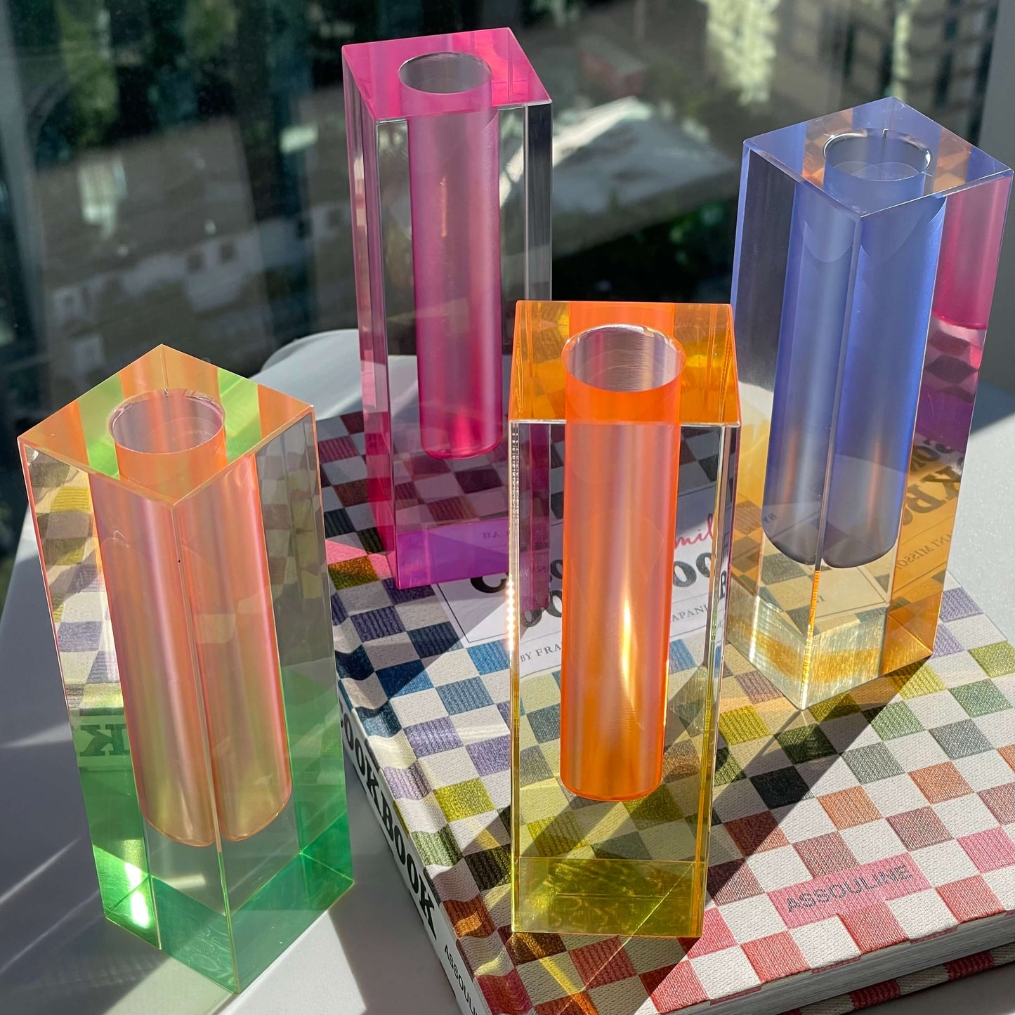 a group of acrylic vase on a table