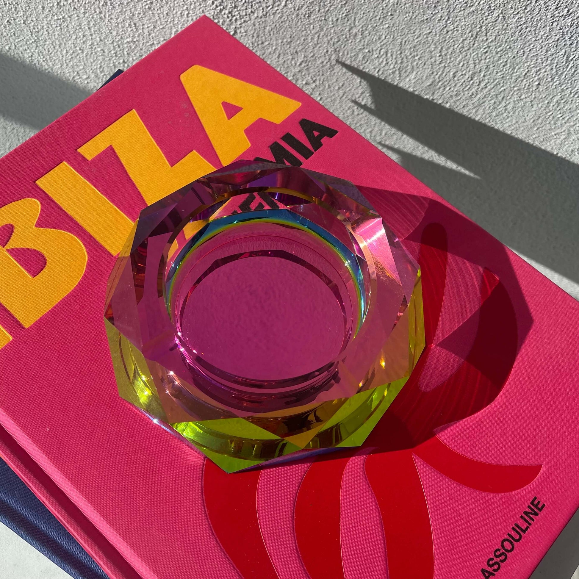 pink decorative glass bowl on a magazzine